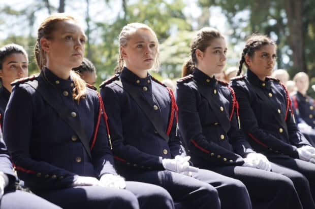 The Motherland Fort Salem TV series cast is dressed in uniform sitting together outdoors, 2K Desktop Wallpaper