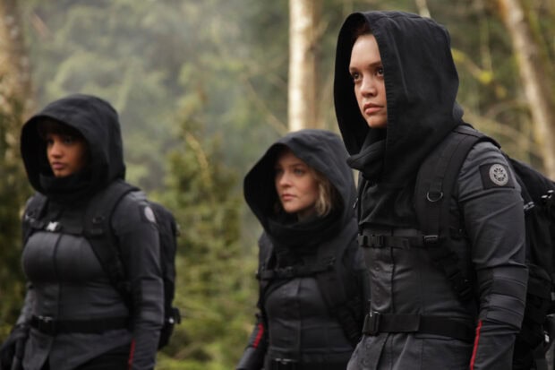 Three women wearing dark tactical outfits in a forest from Motherland Fort Salem Tv Series, 2K Desktop Wallpaper