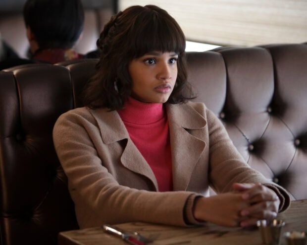 A woman in a tan coat and red turtleneck looks concerned during a conversation, 2K Desktop Wallpaper