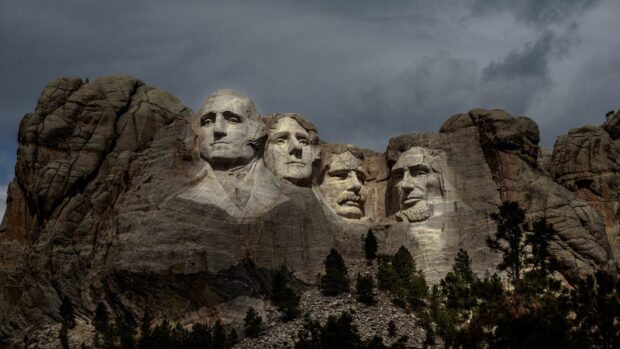 Mount Rushmore national monument features carved faces of four presidents against a cloudy sky, 2K Desktop Wallpaper