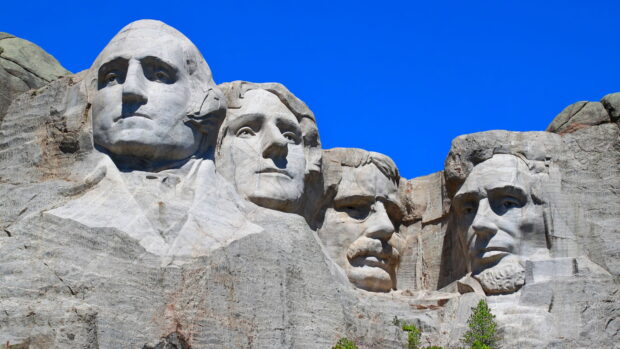 The Mount Rushmore sculpture shows the carved faces of four US presidents against a bright blue sky, HD Desktop Wallpaper