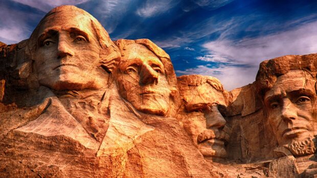 The Mount Rushmore monument carved into the granite face with a vivid blue sky, 4K Desktop Wallpaper