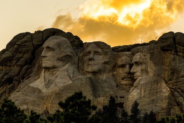 The Mount Rushmore sculptures are illuminated by a golden sunset sky, HD Desktop Wallpaper