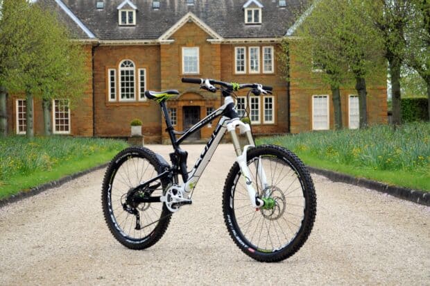 A Cube Bikes Wallpapers mountain bike is parked on a gravel path in front of a traditional country house, HD Desktop Wallpaper