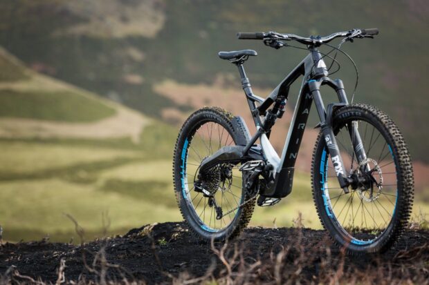 A Marin Bikes mountain bike is parked on a trail in a natural outdoor setting, HD Desktop Wallpaper
