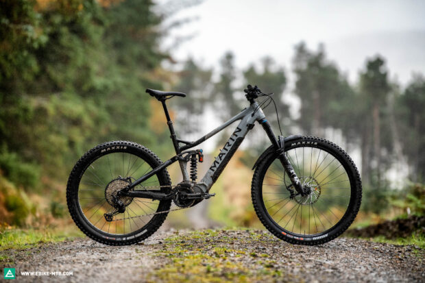 A Marin bike stands on a forest trail surrounded by trees and greenery, HD Desktop Wallpaper
