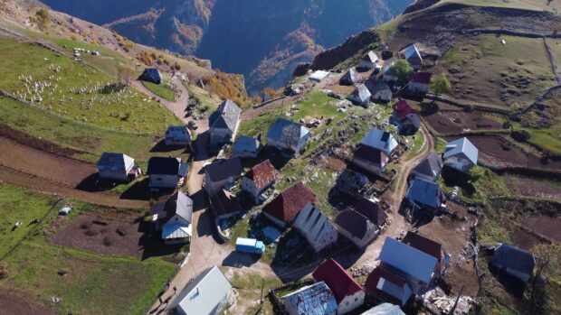 A peaceful village with old rustic houses nestled on a mountainside, 4K Desktop Wallpaper