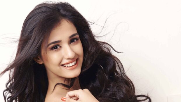 A smiling woman with long dark hair poses for Ms Dhoni The Untold Story wallpapers, 4K Desktop Wallpaper