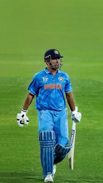 MS Dhoni is walking on the cricket field wearing the India team uniform, HD Phone Wallpaper