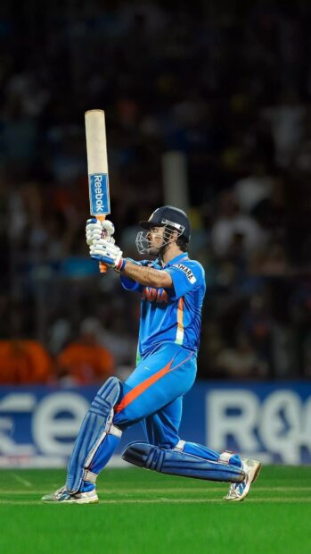 A cricket player wearing India uniform raises the bat after a shot during a match, HD Mobile Wallpaper