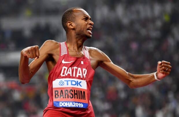 Mutaz Essa Barshim celebrates a victory during an athletic competition wearing a Qatar jersey, HD Desktop Wallpaper