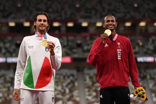 Mutaz Essa Barshim is smiling while holding his gold medal at the Olympics, HD Desktop Wallpaper