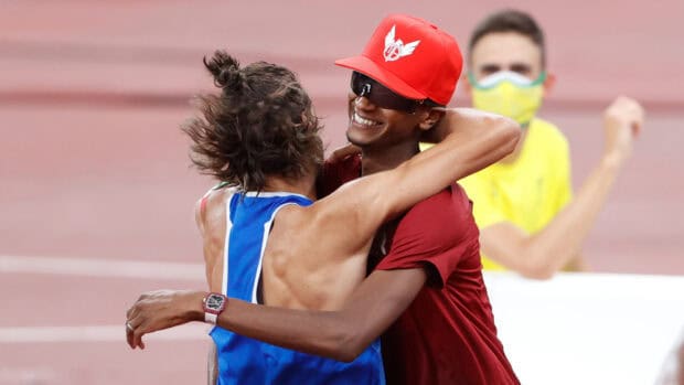 Mutaz Essa Barshim warmly hugging another athlete after an event, HD Desktop Wallpaper