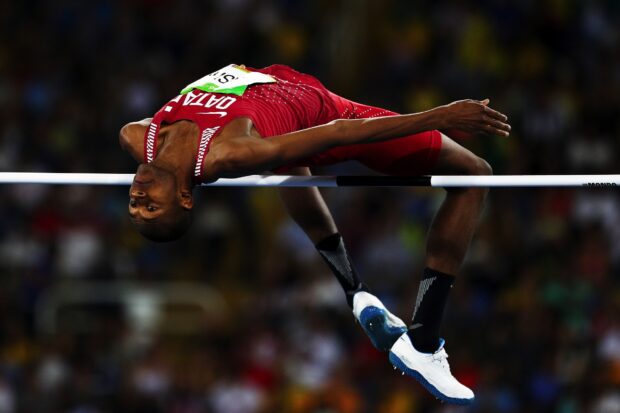 Mutaz Essa Barshim is captured mid air during a high jump event, HD Desktop Wallpaper