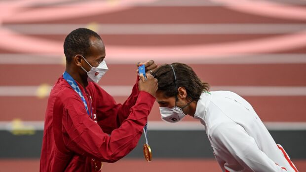 Mutaz Essa Barshim receiving a medal at an athletic event while wearing a mask, 2K Desktop Wallpaper
