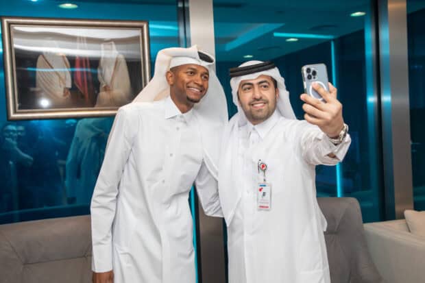Mutaz Essa Barshim is smiling and posing for a selfie with a friend indoors, 2K Desktop Wallpaper