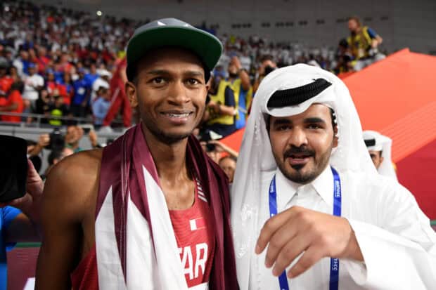 Mutaz Essa Barshim celebrates with a supporter at the sports event, HD Desktop Wallpaper