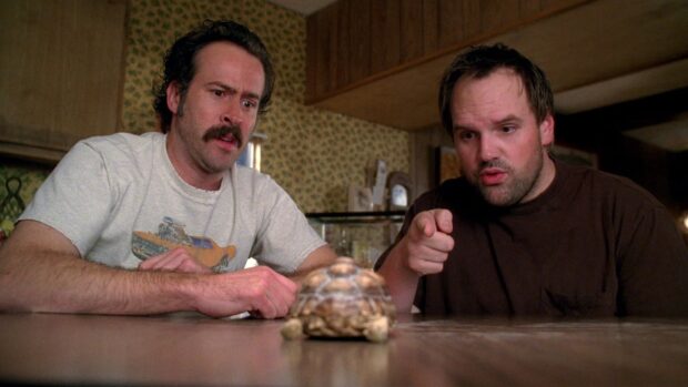 Two men are closely watching a turtle on the table in a scene from the My Name Is Earl tv series, HD Desktop Wallpaper
