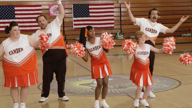 The My Name Is Earl cast is performing a cheer routine in a gym with American flags behind them, HD Desktop Wallpaper