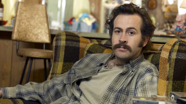 A man with a mustache sitting on a patterned couch in a casual setting from My Name Is Earl, HD Desktop Wallpaper