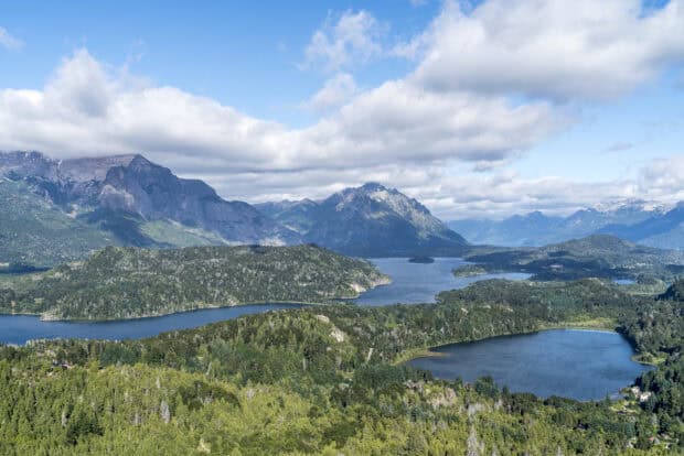 A scenic view of Nahuel Huapi featuring clear blue lakes and lush green forests under a bright sky, HD Desktop Wallpaper