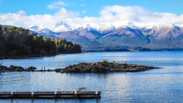 A serene view of Nahuel Huapi with snowy peaks and calm water, HD Desktop Wallpaper