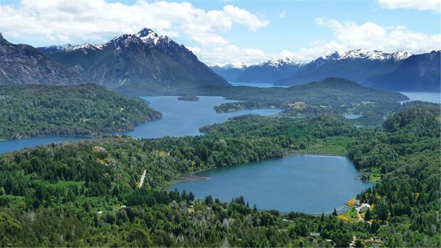 A scenic view of Nahuel Huapi lake surrounded by mountains and forests, HD Desktop Wallpaper