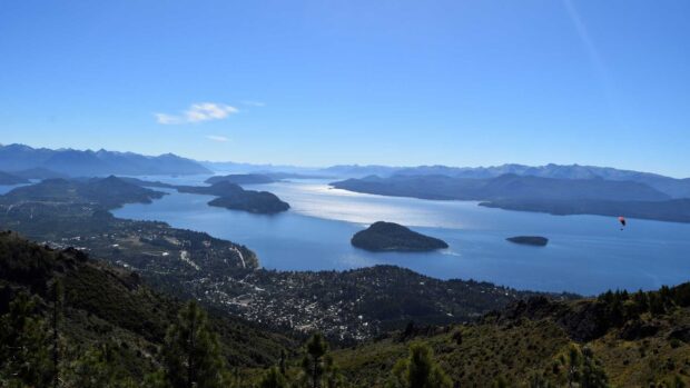 A scenic view of Nahuel Huapi with mountains and forests under a clear sky, HD Desktop Wallpaper