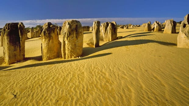 The Nambung National Park features unique desert rock formations under a clear blue sky, HD Desktop Wallpaper