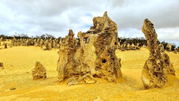 The Nambung National Park showcases unique rock formations under a cloudy sky, 2K Desktop Wallpaper