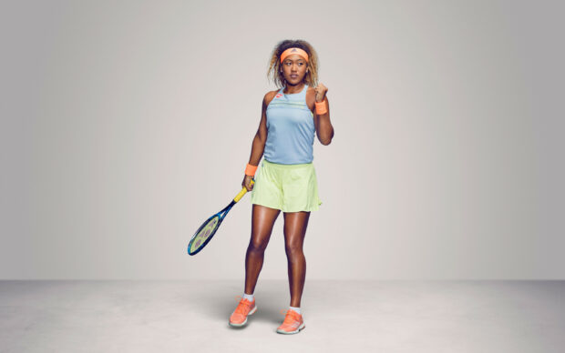 Naomi Osaka showing a confident pose holding a tennis racquet in a sports outfit, 2K Desktop Wallpaper