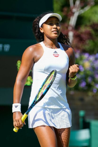 Naomi Osaka celebrates a successful point during a tennis match wearing white sportswear, HD Desktop Wallpaper