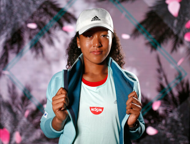 Naomi Osaka stands confidently wearing a blue jacket and white cap, HD Desktop Wallpaper