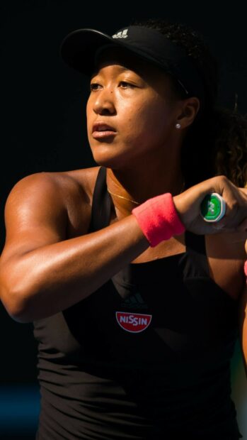Naomi Osaka focused during a tennis match with intense expression, HD Phone Wallpaper