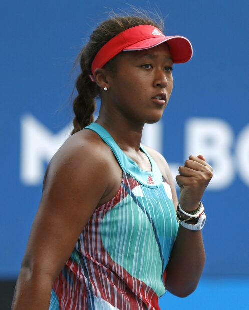Naomi Osaka focused intensely during a tennis match showing determination, 2K Desktop Wallpaper