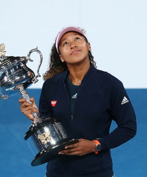 Naomi Osaka holding a silver tennis trophy after winning a championship, HD Desktop Wallpaper