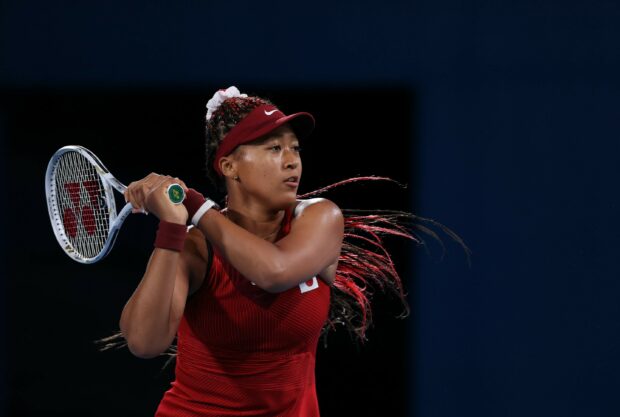 Naomi Osaka is focused preparing for a backhand shot in a tennis game, 2K Desktop Wallpaper
