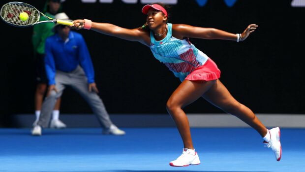 Naomi Osaka playing tennis with a stretched arm and focused expression, 2K Desktop Wallpaper