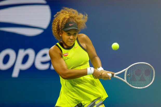 Naomi Osaka is hitting a backhand shot during a tennis match, HD Desktop Wallpaper