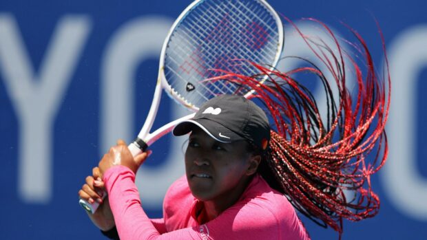 Naomi Osaka focuses intensely during a tennis match hitting a powerful backhand, 2K Desktop Wallpaper