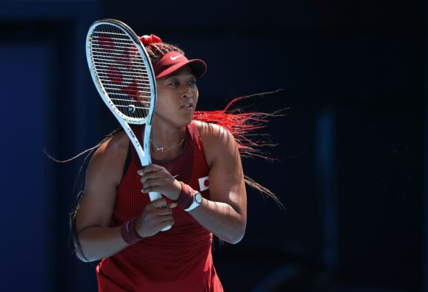 Naomi Osaka focused during a tennis match wearing red sportswear, HD Desktop Wallpaper