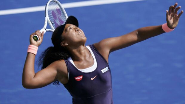 Naomi Osaka prepares to serve with focus on a blue tennis court, HD Desktop Wallpaper