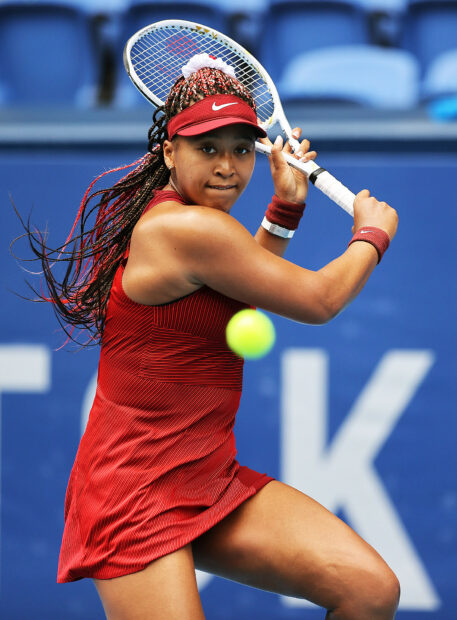 Naomi Osaka focuses intensely before hitting a backhand shot during a match, HD Desktop Wallpaper
