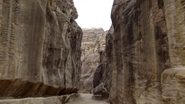 The narrow canyon path in Petra Jordan showcases towering ancient rock formations, Petra Jordan Wallpapers, 2K Desktop Wallpaper