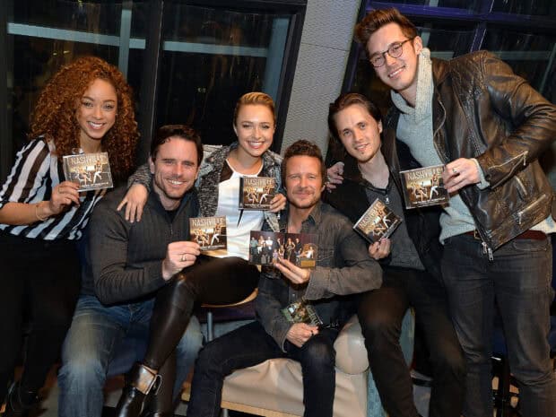 The Nashville tv series cast is smiling and holding albums in a cozy setting, HD Desktop Wallpaper