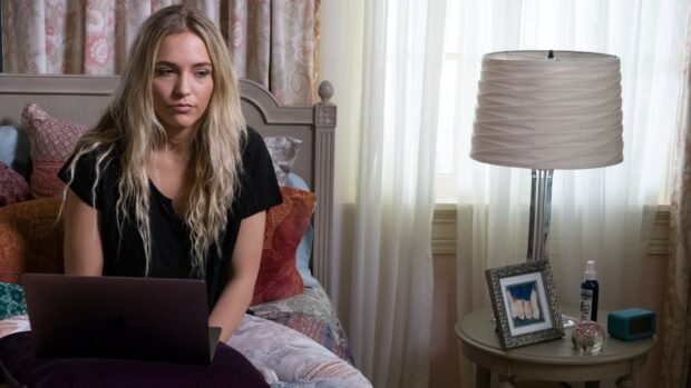 A woman from Nashville TV series sits on her bed with a laptop in a cozy room, 4K Desktop Wallpaper