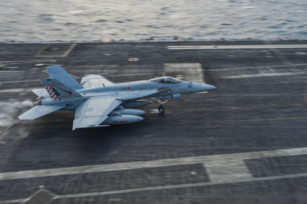 A Navy jet fighter landing on an aircraft carrier deck, HD Desktop Wallpaper