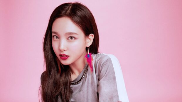 Nayeon Wallpapers shows a close up portrait with pink background and colorful feather earrings, 4K Desktop Wallpaper