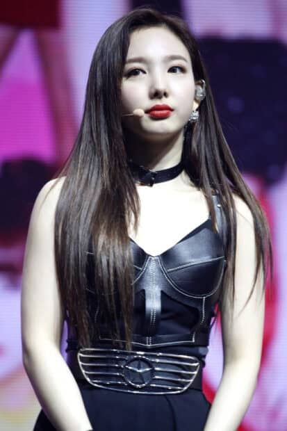 Nayeon wallpapers showing a close up of her in a black leather outfit with long hair, HD Mobile Wallpaper