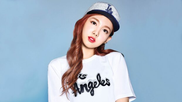 Nayeon is posing wearing a white shirt and a cap against a blue background, 4K Desktop Wallpaper